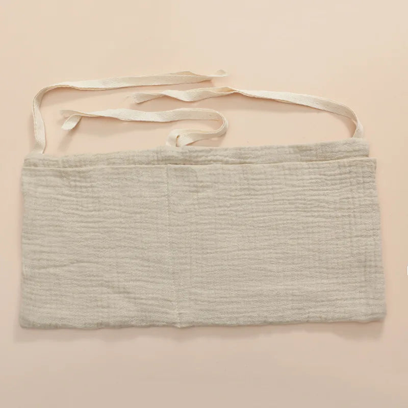 Organisateur de lit bébé multi-poches pour couches et accessoires