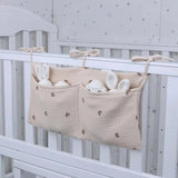 Organisateur de lit bébé multi-poches pour couches et accessoires